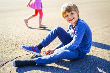 Dışarıda poz veren 9 yaşındaki sarışın bir çocuğun portresi.