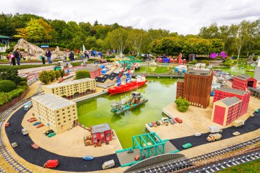 WINDSOR, BİRLİK KINGDOM - 12 HAZİRAN 2020 - Miniland 'daki turistler ve çocuklar, dünyanın dört bir yanındaki Legoland tema parkındaki anıtları ve şehirleri resmeden 40 milyon Lego tuğlasından oluşan bir minyatür park