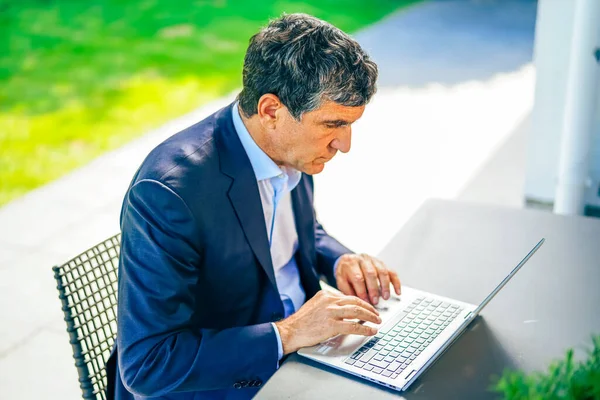 businessman working on laptop computer in the park