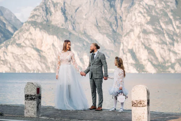 Italien, Gardasee. Schöne Familie am Ufer des Gardasees in Italien am Fuße der Alpen. Vater, Mutter und Tochter in Italien — Stockfoto