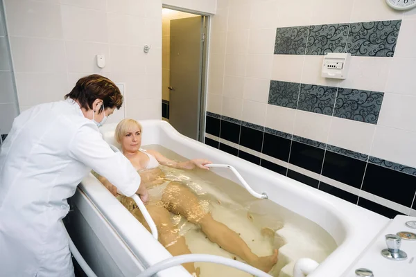 the procedure of underwater shower massage in the sanatorium.Girl on the procedure of underwater massage