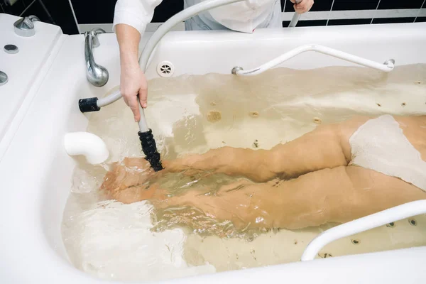 the procedure of underwater shower massage in the sanatorium.Girl on the procedure of underwater massage.
