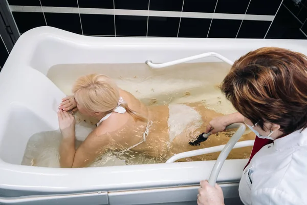 the procedure of underwater shower massage in the sanatorium.Girl on the procedure of underwater massage.