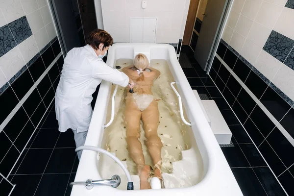 the procedure of underwater shower massage in the sanatorium.Girl on the procedure of underwater massage.