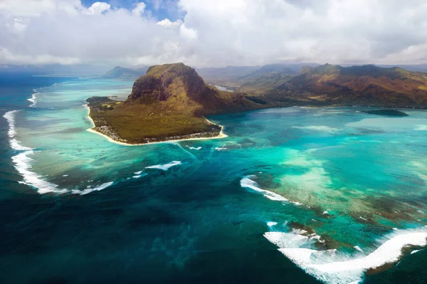 A bird\'s-eye view of Le Morne Brabant, a UNESCO world heritage site.Coral reef of the island of Mauritius.Storm cloud.
