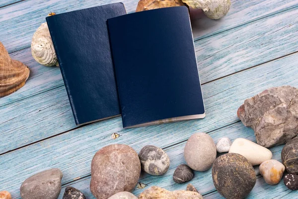 蓝色木制背景上的文件 石头和贝壳 旅行主题 — 图库照片