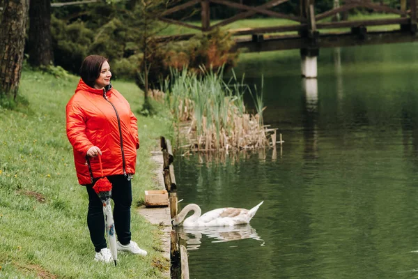 Una Mujer Con Una Chaqueta Roja Llevando Paraguas Pasea Por — Foto de Stock