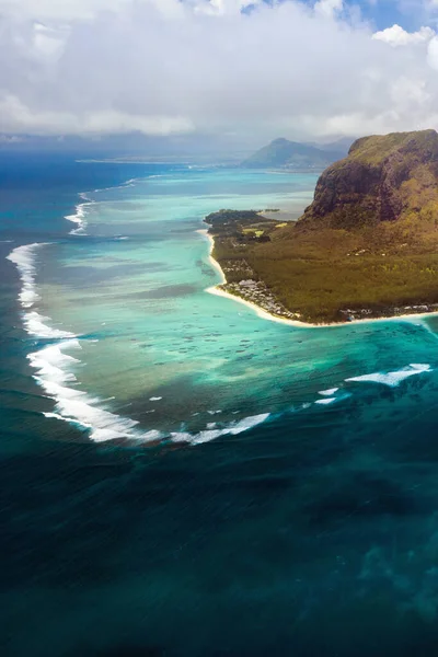 A bird\'s-eye view of Le Morne Brabant, a UNESCO world heritage site.Coral reef of the island of Mauritius.Storm cloud.