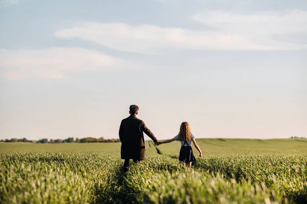 Teenage Daughter Walks Her Father Meadow Holding Hands Evening — Zdjęcie stockowe