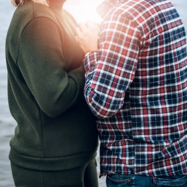 Bir erkek ve bir kız sarılıp el ele tutuşuyorlar. Aşkın sıcaklığı, güneşin parlaklığı.