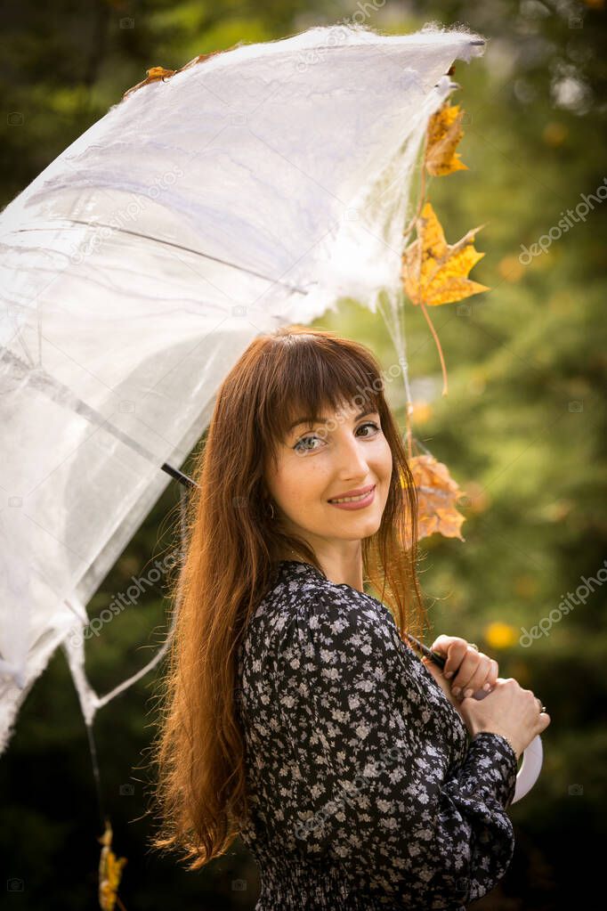 Halloween. Beautiful young woman in a festive mood at a Halloween picnic. Warm autumn October day. Emotion concept.