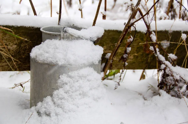 Winter. Aluminum milk container in the snow. Milk can in the snow.