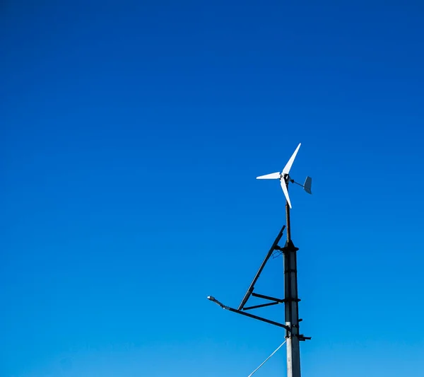 Household home turbine on a clear day. With these generators, households save energy costs.