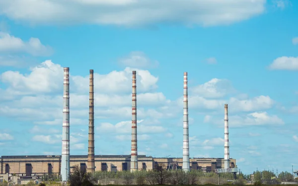 Coal power plant. Thermal energy concept. Chimneys against the blue sky.