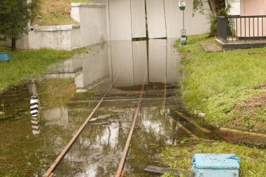 Halk parkı yağmurdan sırılsıklam olmuş. Su dolu park. Islak banklar. Yağmurdan sonra su dolu park. Sağanak yağmurdan sonra boş park..