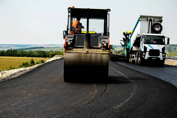 Repair of roads. Laying asphalt with a roller.