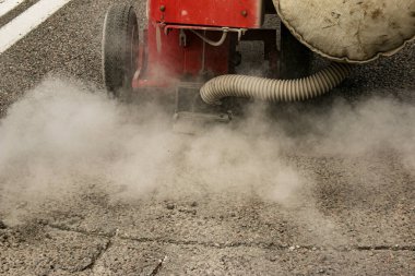 Asfalt asfalt döşeme için yüzey hazırlanıyor. Enkazın kaldırılması ve özel ekipmanlarla çatlakların hazırlanması.