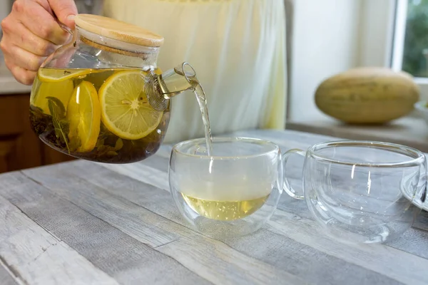 Woman Pours Fresh Brewed Tea Mint Lemon Cup Tea Drinking — Stock Photo, Image