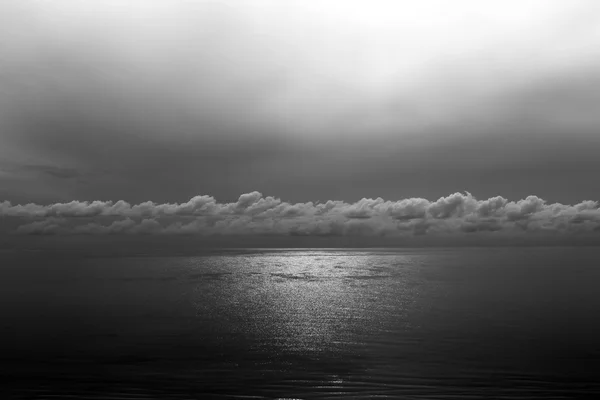 Sun reflection ocean glistening with cloud toned in black and wh — Stock Photo, Image