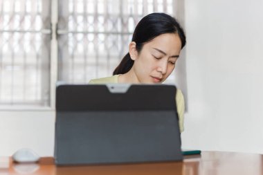 Dizüstü bilgisayarla çalışırken akıllı telefona benzeyen güzel bir kadın..