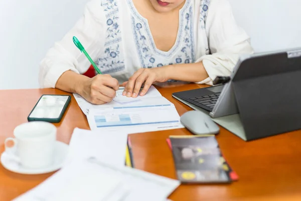Woman paying bills online and writing notes at home. — Stock Photo, Image