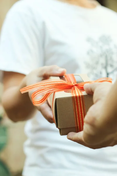 Hands giving and receiving a present