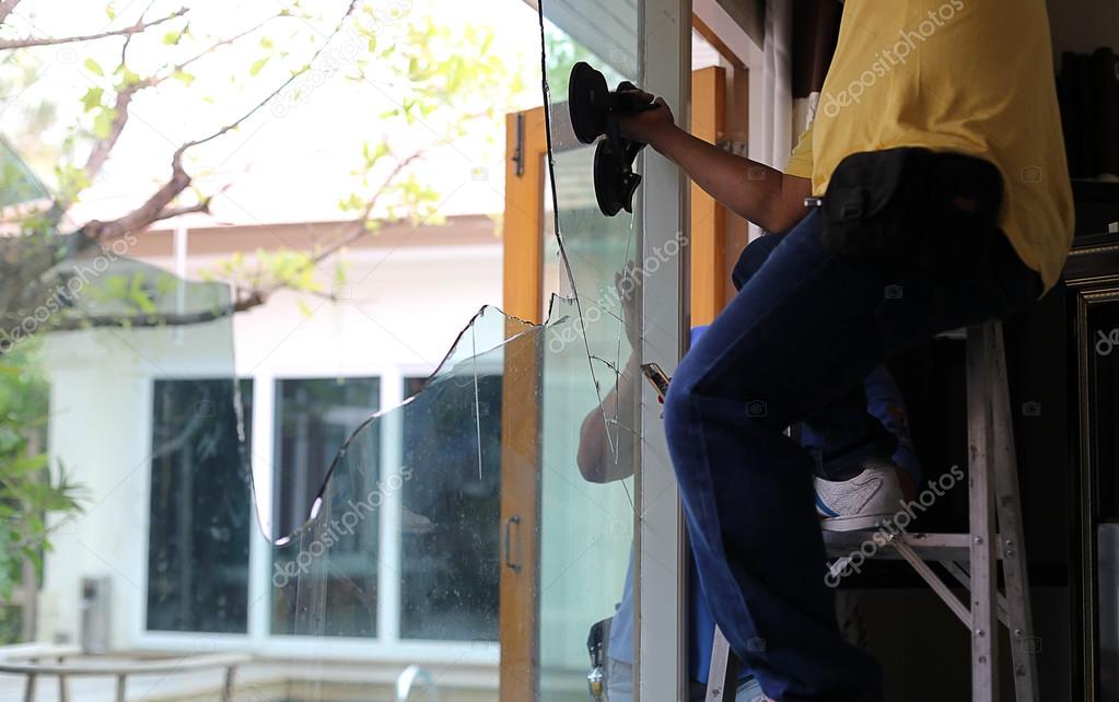 Repair man working on broken glass