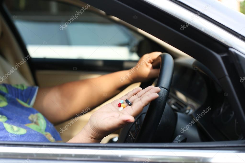 Women taking pills inside his car