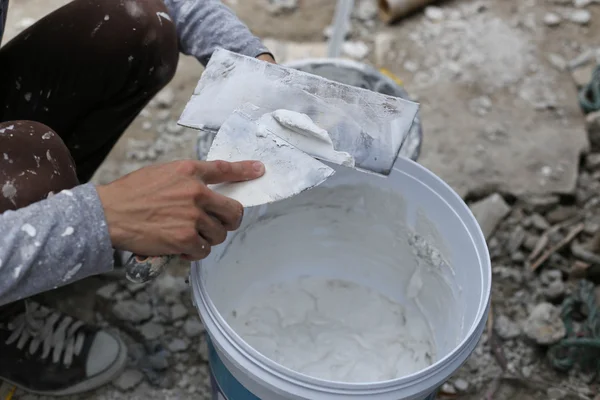 Plasterer mixing a plaster in bucket — Stock Image Plasterer mixing a plaster in bucket Royalty Free Stock Images