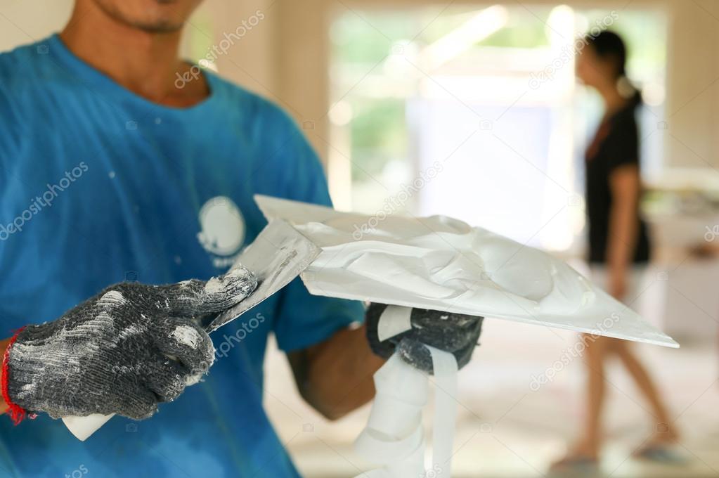 Plasterer mixing a plaster on a tray
