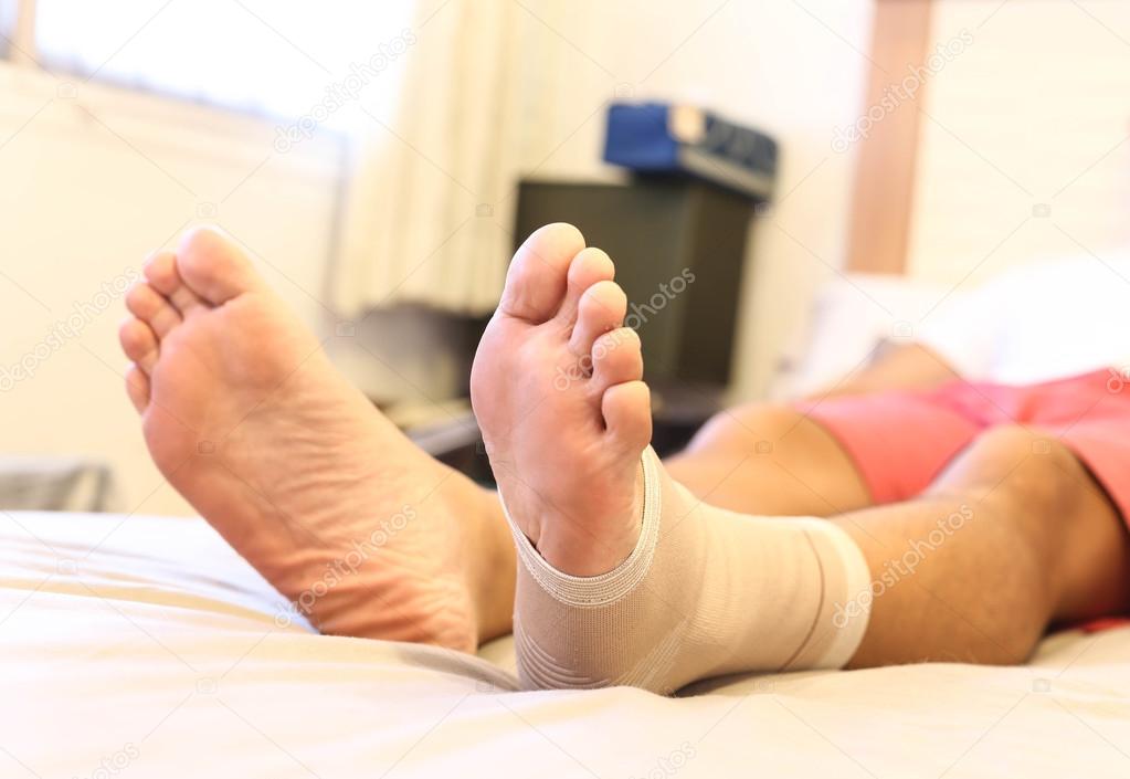 Man lying on the bed with Injured ankle