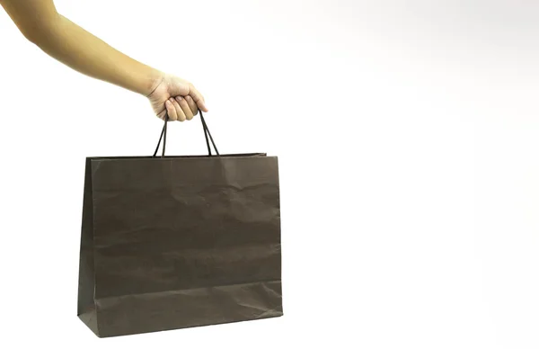 Handen håller en shopping papperspåse isolerade — Stockfoto