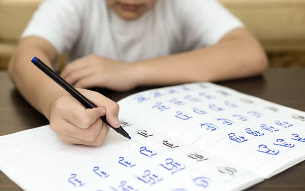 Niño de la escuela haciendo trabajo en casa escritura a mano responde a un ejercicio —  Fotos de Stock