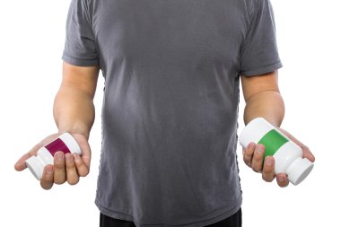 Man comparing bottles of medicine