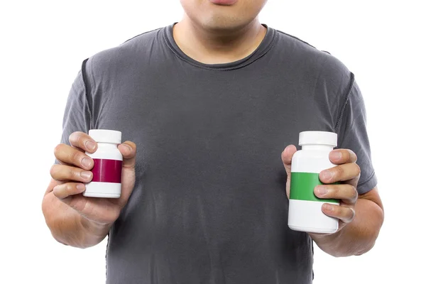 Man comparing bottles of medicine — Stock Photo, Image