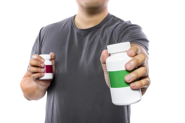Man comparing bottles of medicine — Stockfoto