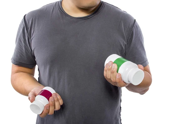 Man comparing bottles of medicine — Zdjęcie stockowe