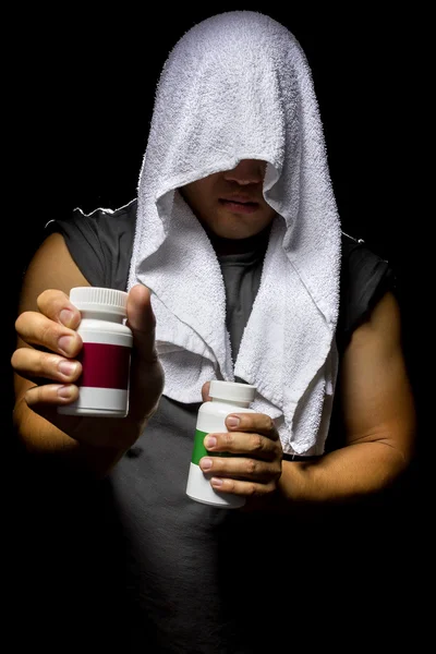 Male with bottles of energy booster supplements — Stockfoto