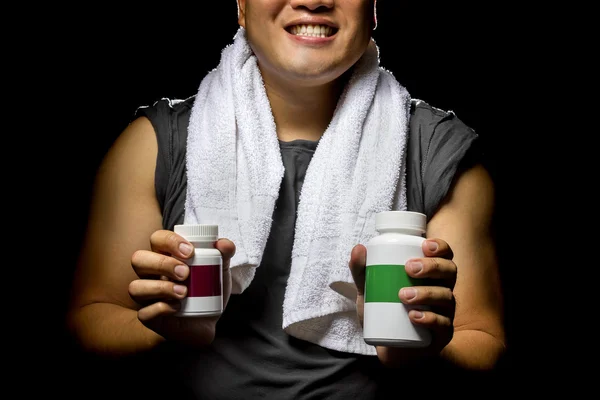 Male with bottles of energy booster supplements — Stock Fotó