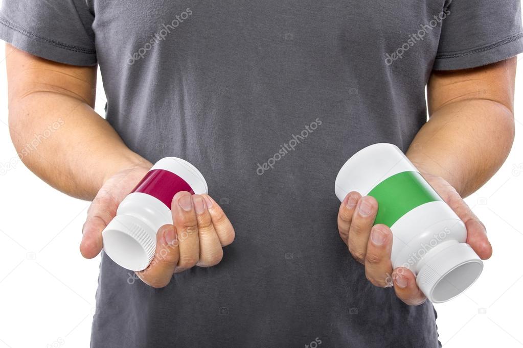 Man comparing bottles of medicine