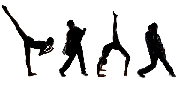 Силуэты танцоров, позирующих — стоковое фото