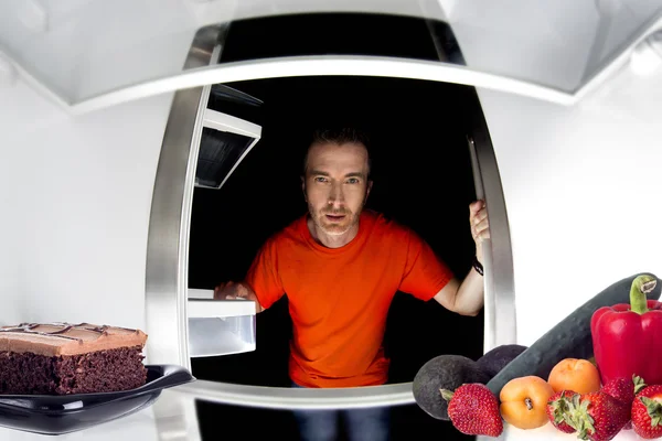 Man looking inside fridge — Stock Photo, Image
