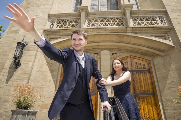 Groom pretending to run away from bride — Stock Photo, Image