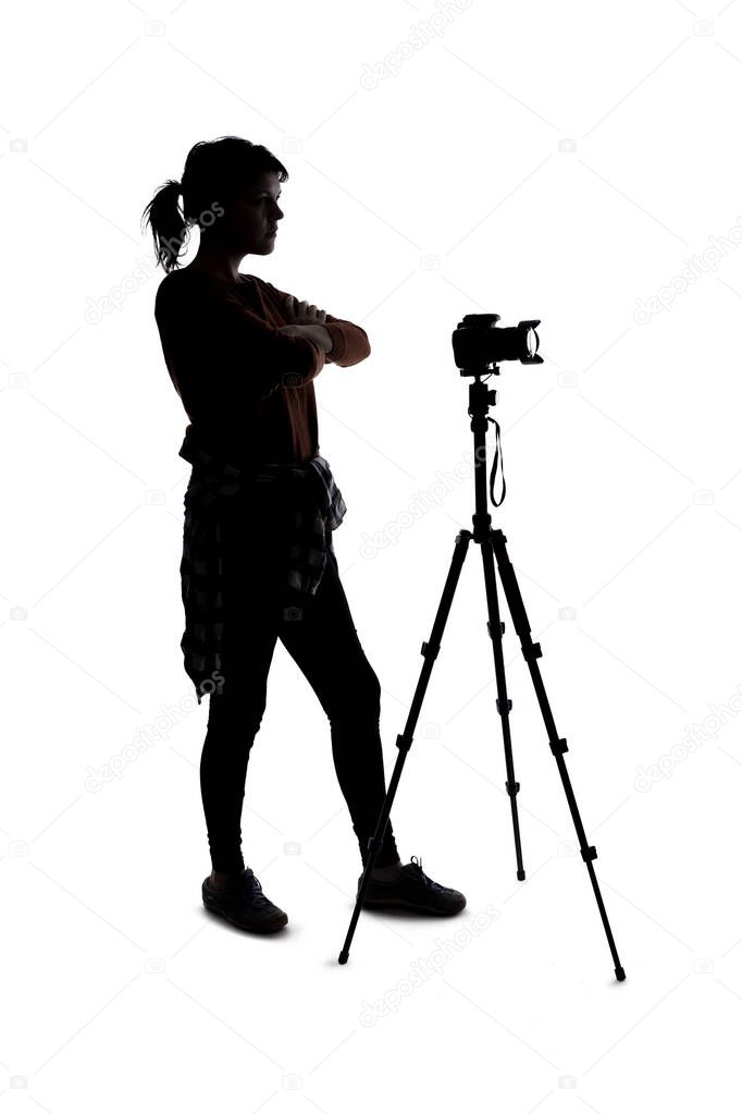 Silhouette of a photographer with a camera on a white background isolated for composites. She is posed as if angry or frustrated