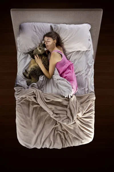 Young teenager sleeping with a pet cat — Stock Photo, Image