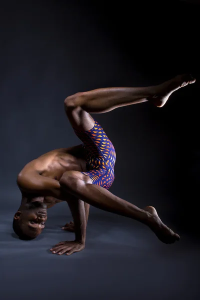 Black man doing upside down yoga Stock Photo