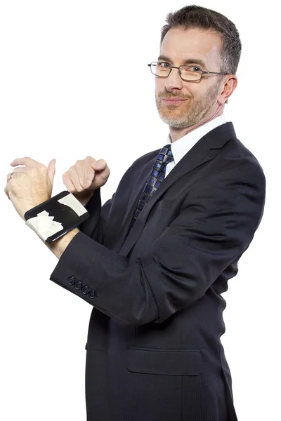 Businessman tapes a cellphone as a DIY smartwatch — Stock Photo, Image