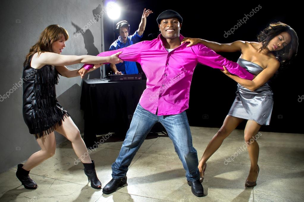 Female rivals pulling man — Stock Photo © innovatedcaptures 64285777