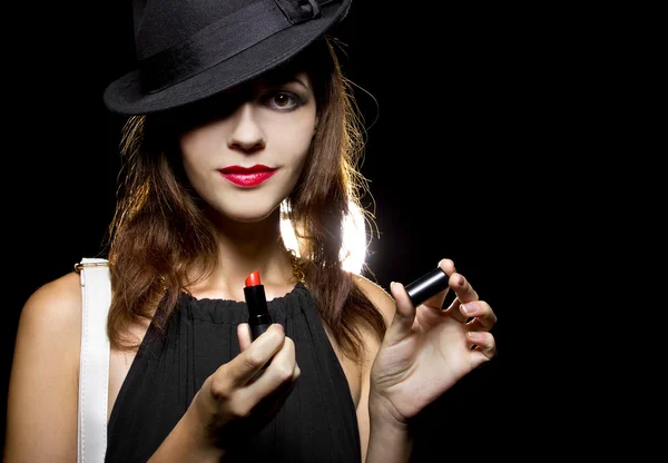 Female putting on red lipstick — Stock Photo, Image