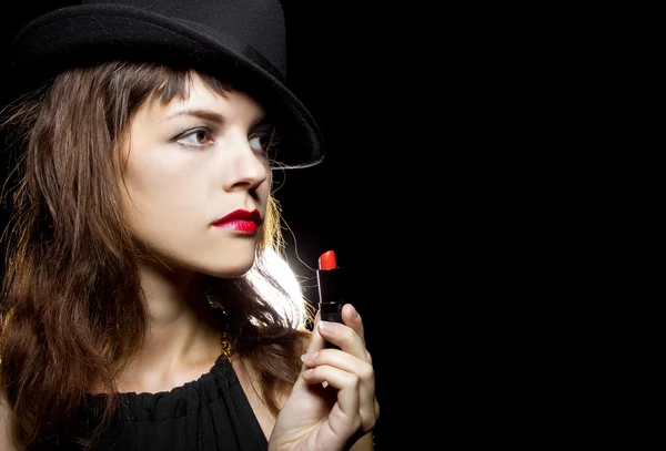 Female putting on red lipstick — Stock Photo, Image